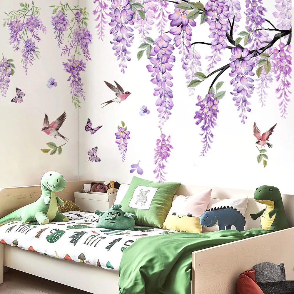 A bedroom wall decorated with watercolor wisteria tree decals featuring purple flowers, birds, and butterflies.