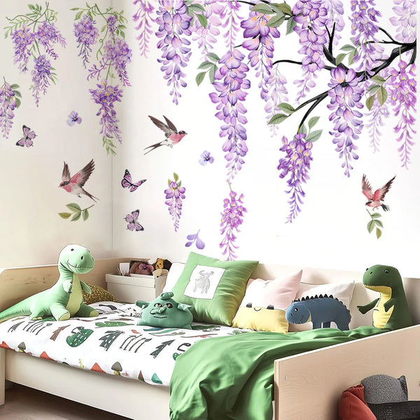 A bedroom wall decorated with watercolor wisteria tree decals featuring purple flowers, birds, and butterflies.
