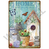 A vintage metal sign featuring a watercolor illustration of a house with a star, flowers, and butterflies on a teal backgroun