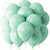 A cluster of light sage green latex balloons tied with green ribbons.
