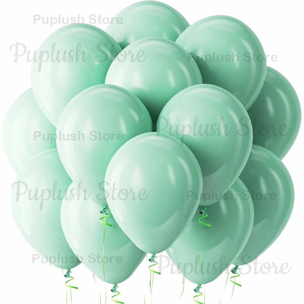 A cluster of light sage green latex balloons tied with green ribbons.