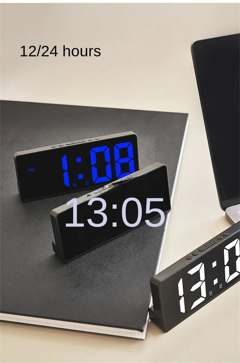 A black LED digital alarm clock displaying 1:08 is shown on a dark surface.