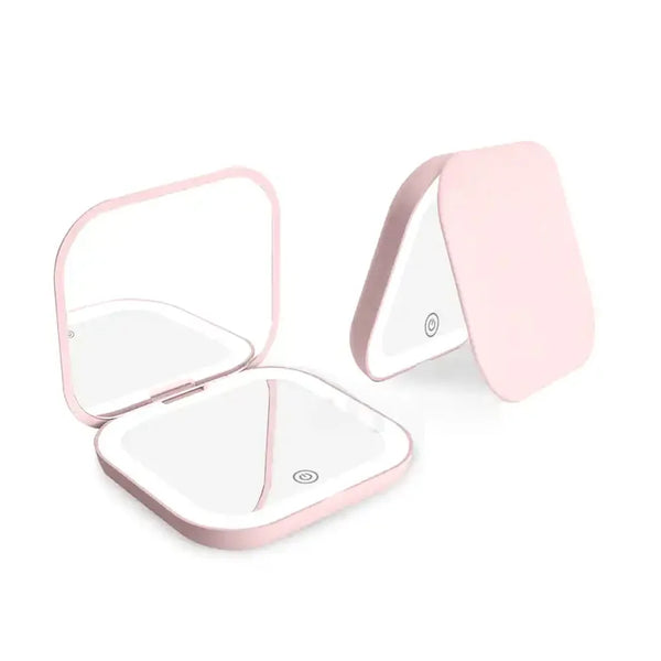 Espejo de maquillaje portátil plegable rosa con luz LED, mostrado abierto y cerrado.