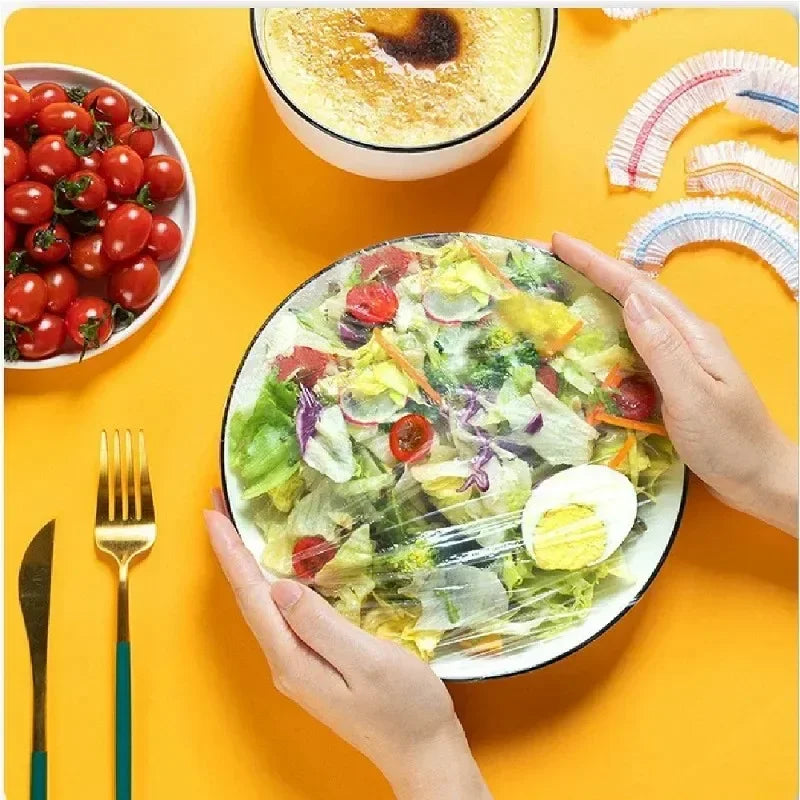 Hands are serving a salad in a bowl on a yellow plate with fresh vegetables and a sliced hard-boiled egg.