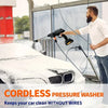 A man is using a cordless pressure washer to clean the front of a white car.