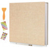 A beige linen scrapbook photo album with a wooden tool and self-adhesive pages displayed on a white background.