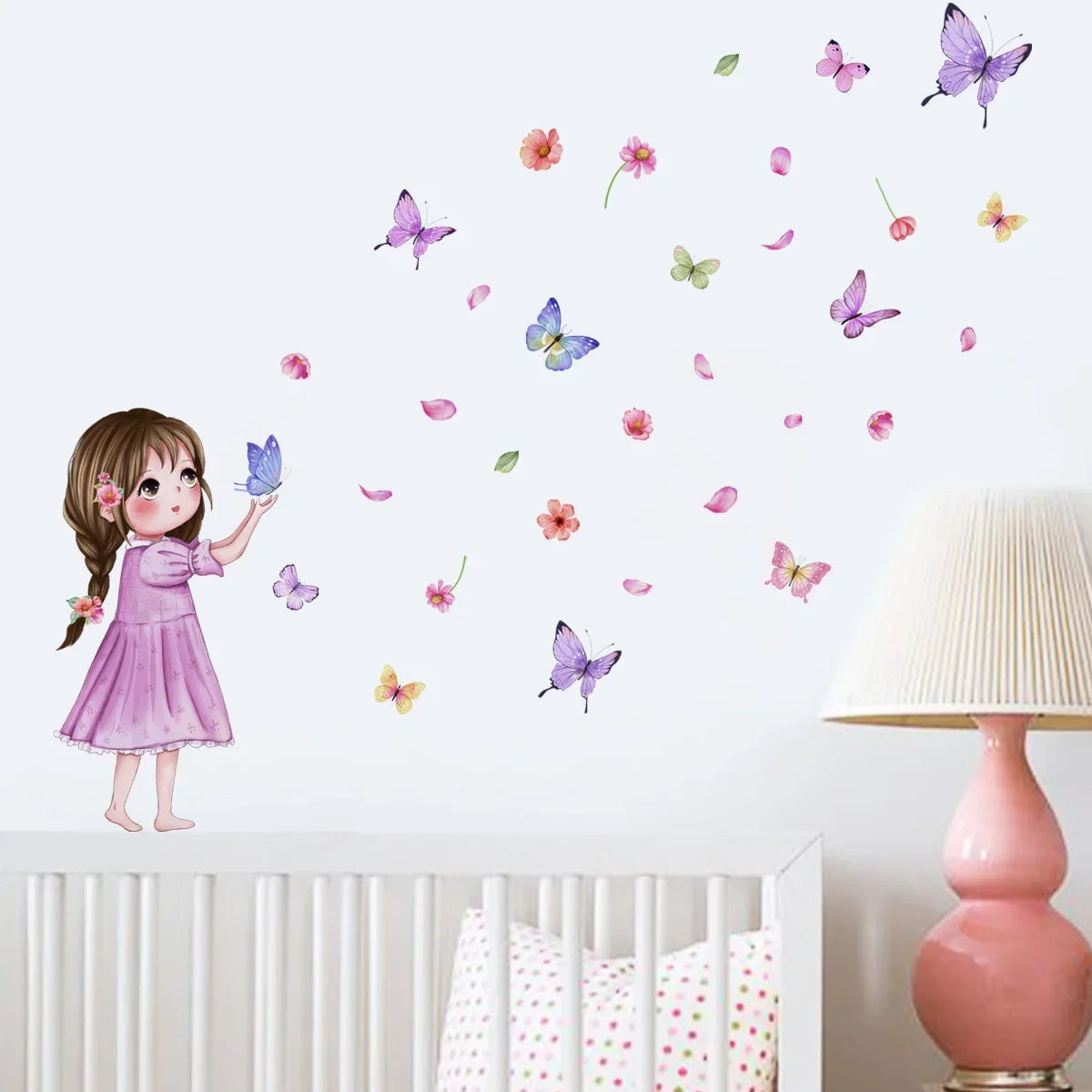 A girl in a pink dress is shown with numerous colorful butterflies flying around her on a white wall.