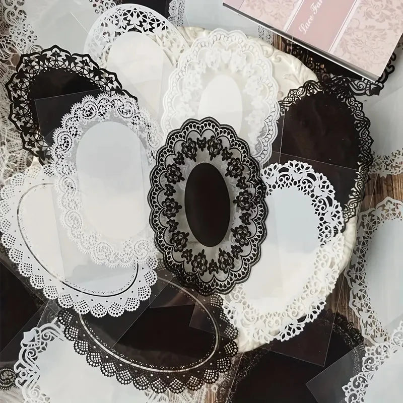 A collection of black and white lace stickers and die-cut shapes for crafting projects.
