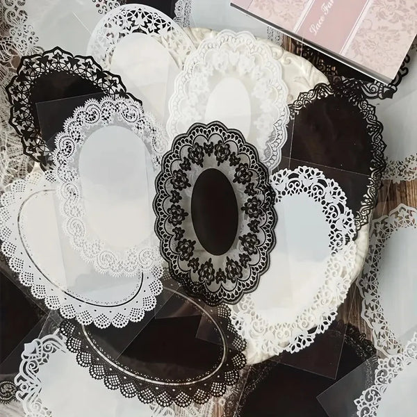 A collection of black and white lace stickers and die-cut shapes for crafting projects.