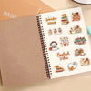 A spiral-bound notebook features various cute ghost and book designs related to autumn and reading themes.