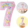 Pink glitter acrylic number 7 birthday candle and macaron cake display
