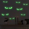 A dark gray wall decorated with glowing green eye shapes, some of which are shaped like bats.