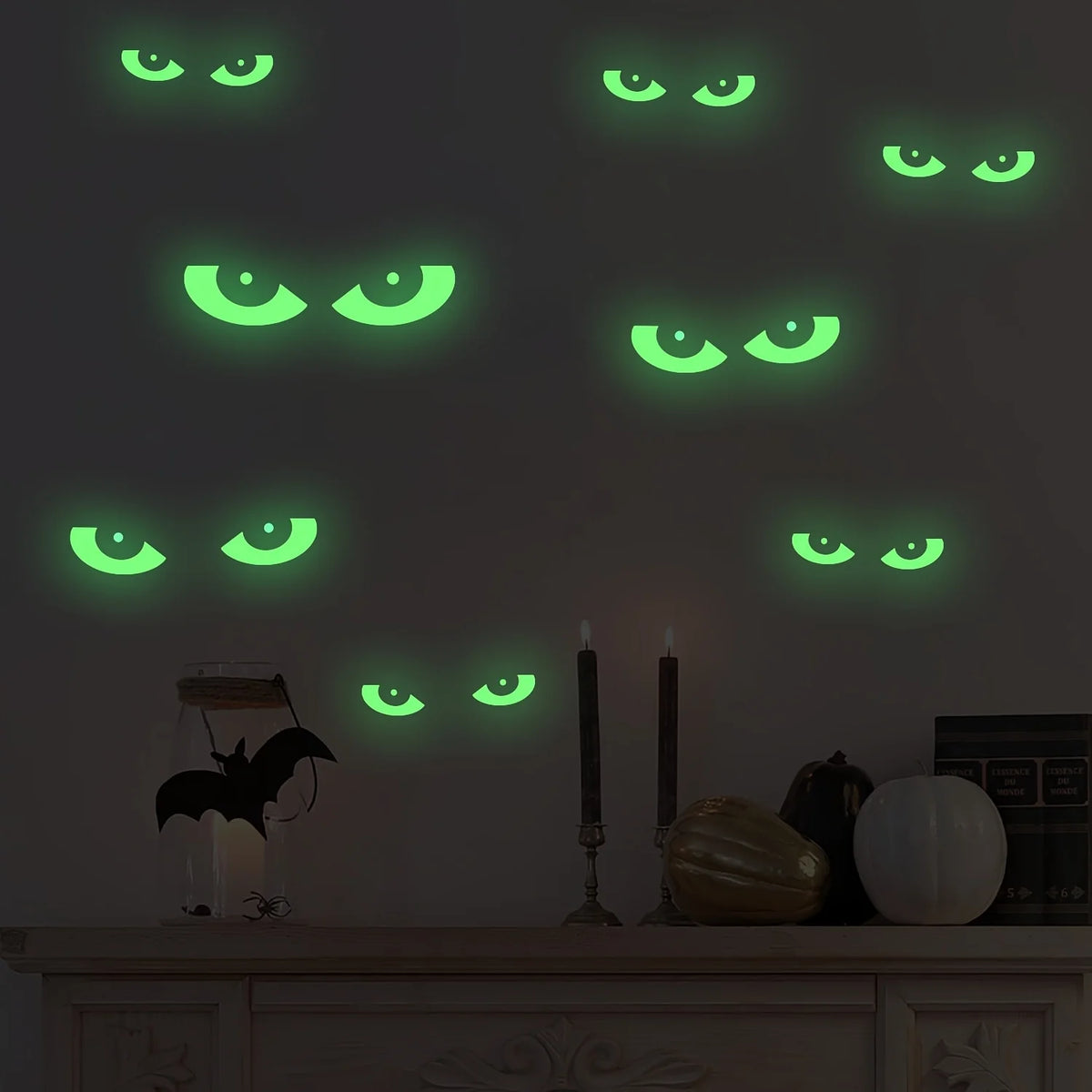 A dark gray wall decorated with glowing green eye shapes, some of which are shaped like bats.