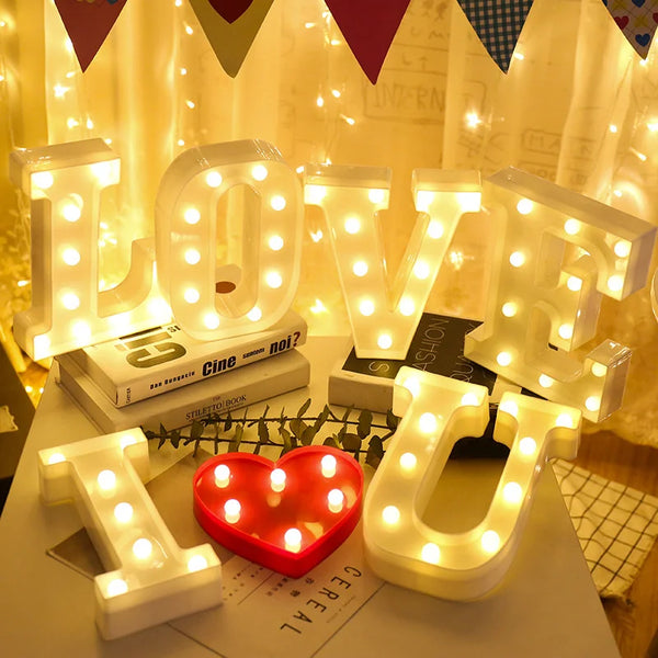 Warm white LED alphabet letter lights spelling LOVE and U with a red heart shape