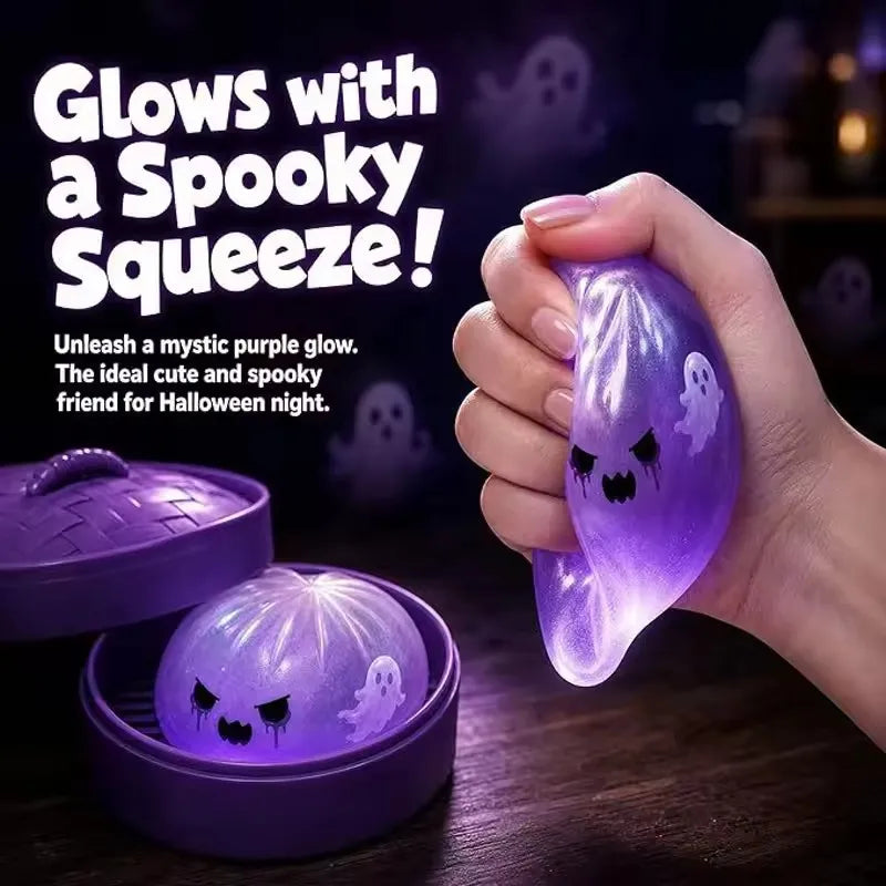 A hand holds a glowing purple silicone fidget dumpling product with a spooky face design.