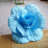 A light blue silk foam rose flower with layered petals displayed on a wooden surface.