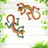 Handcrafted metal gecko wall art featuring colorful, vibrant geckos against a white wooden background.