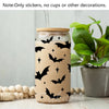 A glass jar decorated with black bat silhouette vinyl stickers on a light beige background.
