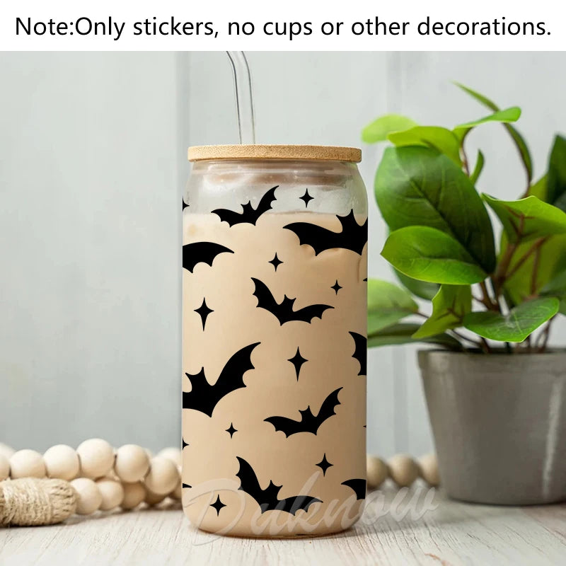 A glass jar decorated with black bat silhouette vinyl stickers on a light beige background.