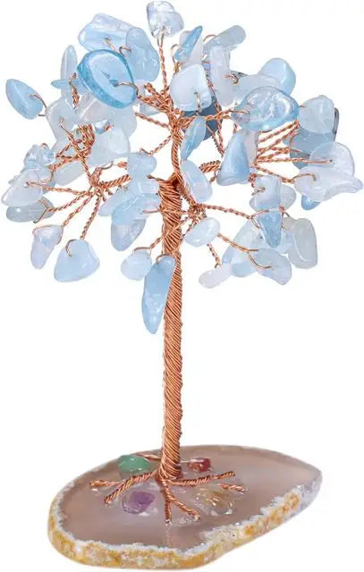 A crystal money tree decor featuring light blue translucent leaves on a wooden branch and a pink base.