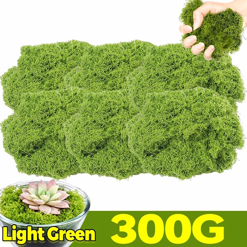 A hand is holding a large clump of light green artificial moss for home décor and DIY projects.
