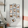 A white refrigerator door displays a grid of small black photo frames featuring family and candid moments.