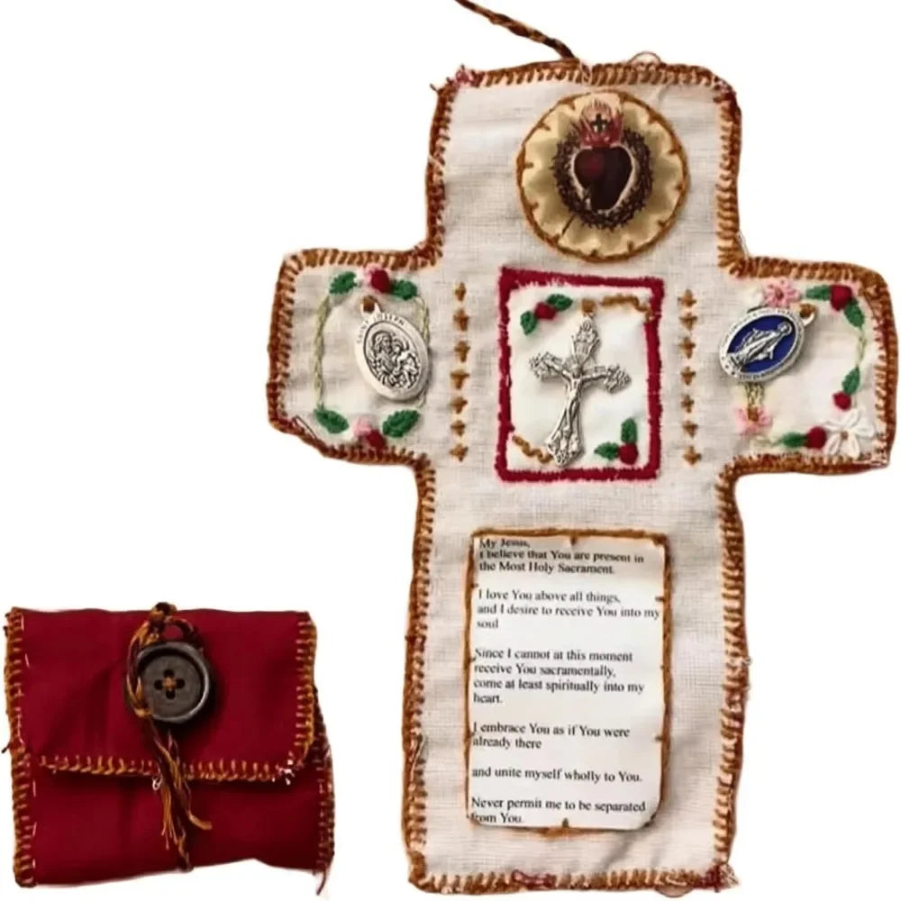 Hand sewn silver prayer cross decoration on a white fabric cross with red embroidery.