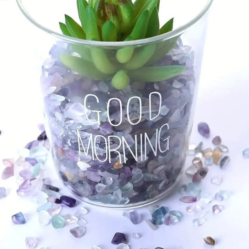 Clear glass jar filled with purple and green tumbled gemstone chips used for crafts and jewelry making