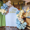 A display of blue and cream balloons arranged in clusters for a birthday party decoration