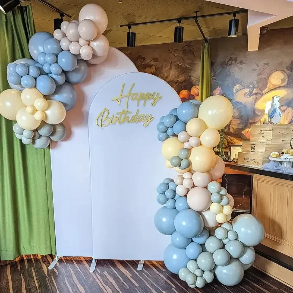 A display of blue and cream balloons arranged in clusters for a birthday party decoration