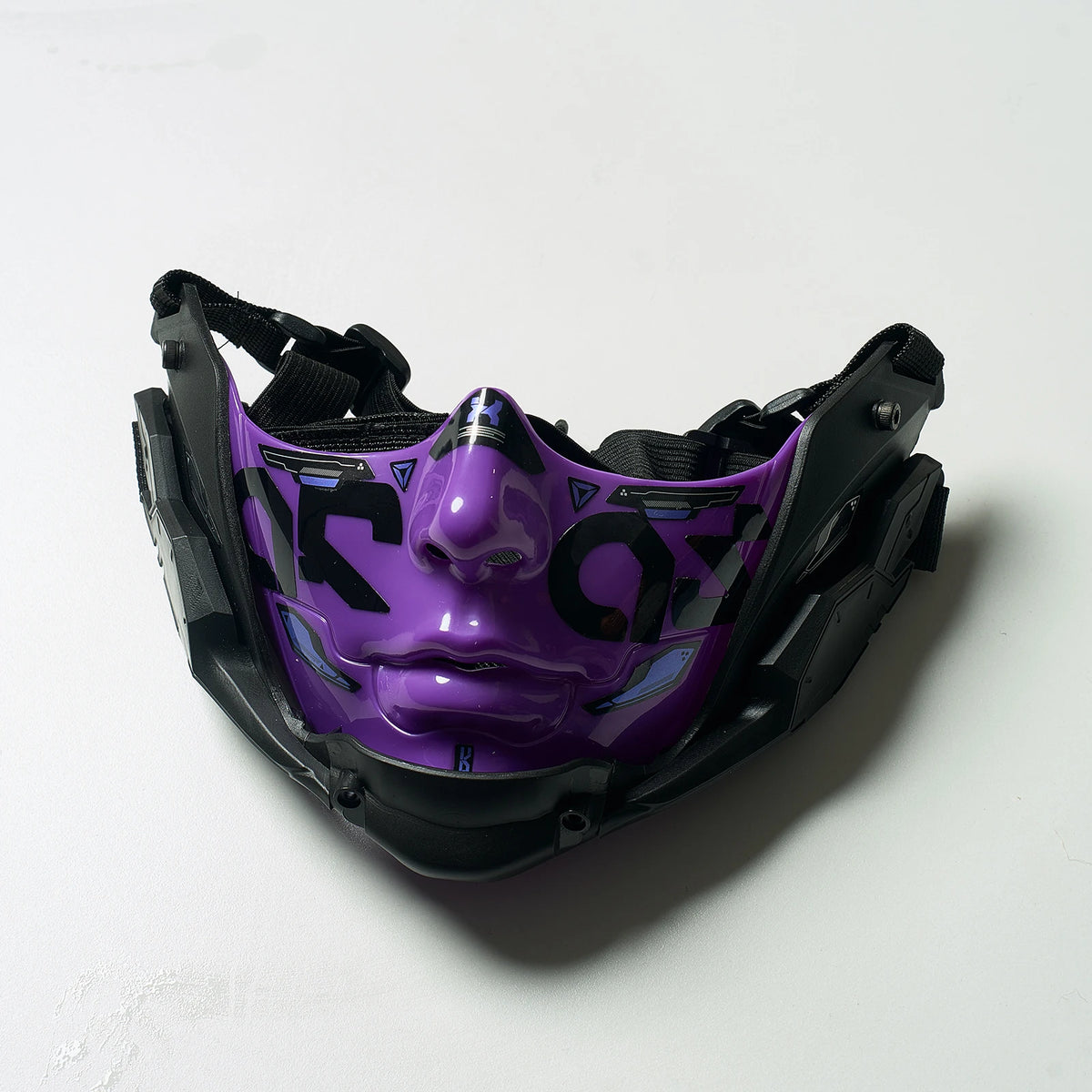 A purple and black half face mask with a stylized cybernetic design.