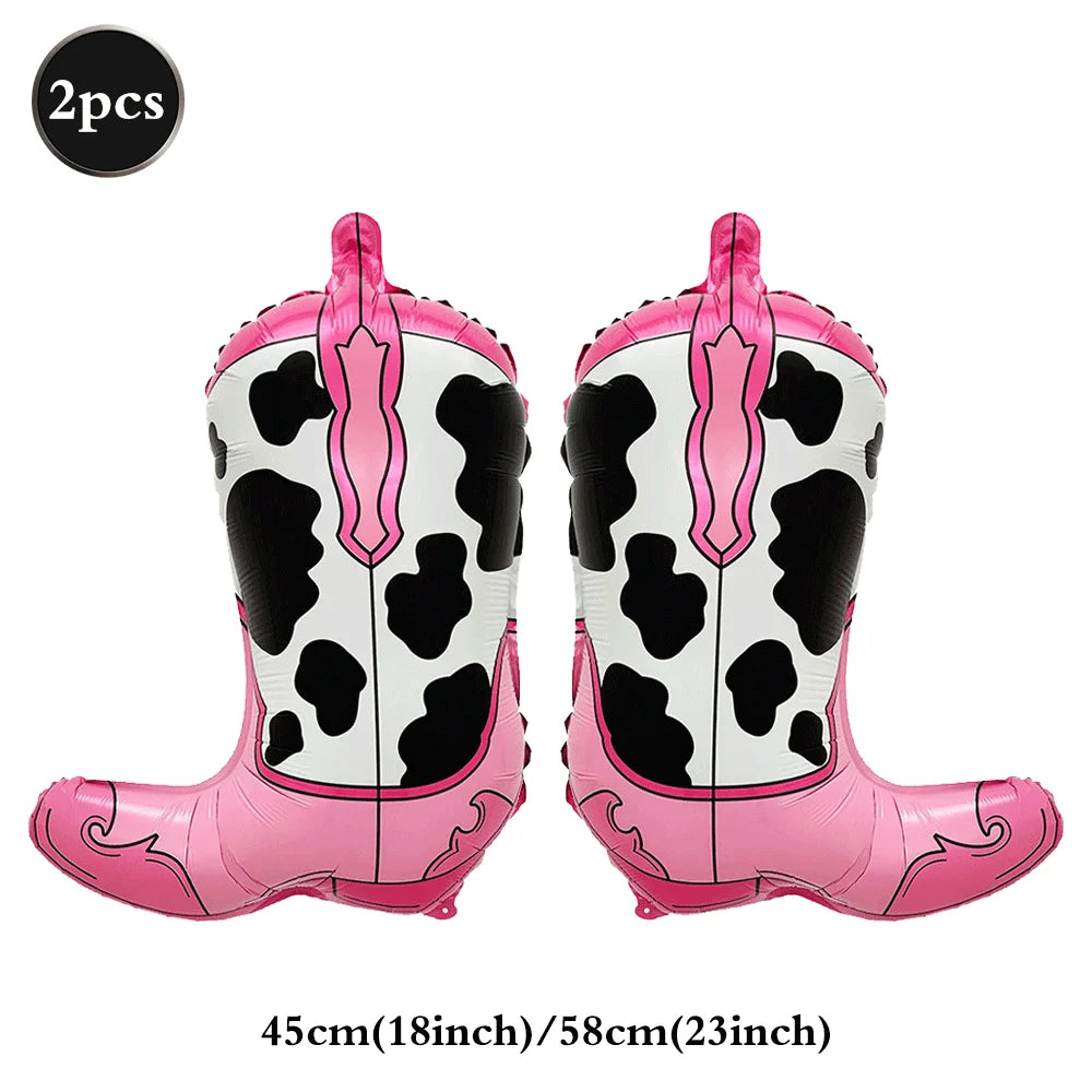 A pair of pink and black cow print foil horse number balloons.
