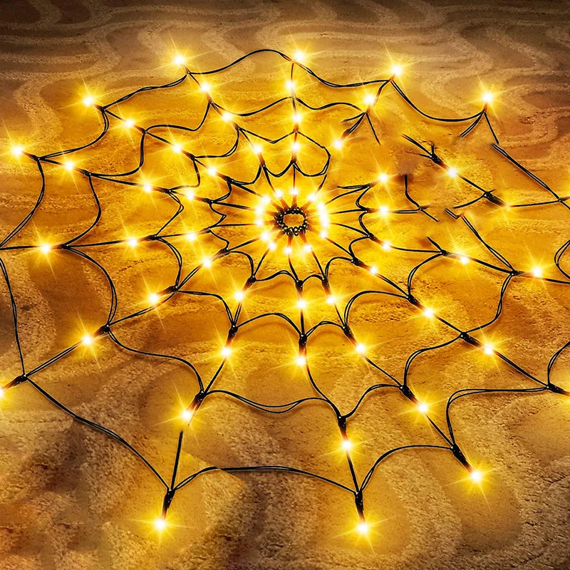 Golden LED string lights shaped like a spider web pattern illuminating a textured surface.