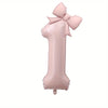 A large pink foil number balloon shaped like the number 1 with a bow.