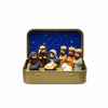 A classic PVC Christmas nativity scene figurine set featuring figures and animals in a gold-colored storage tin.