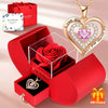 A gold heart pendant necklace is displayed alongside a red gift box containing a red rose and a small pendant.