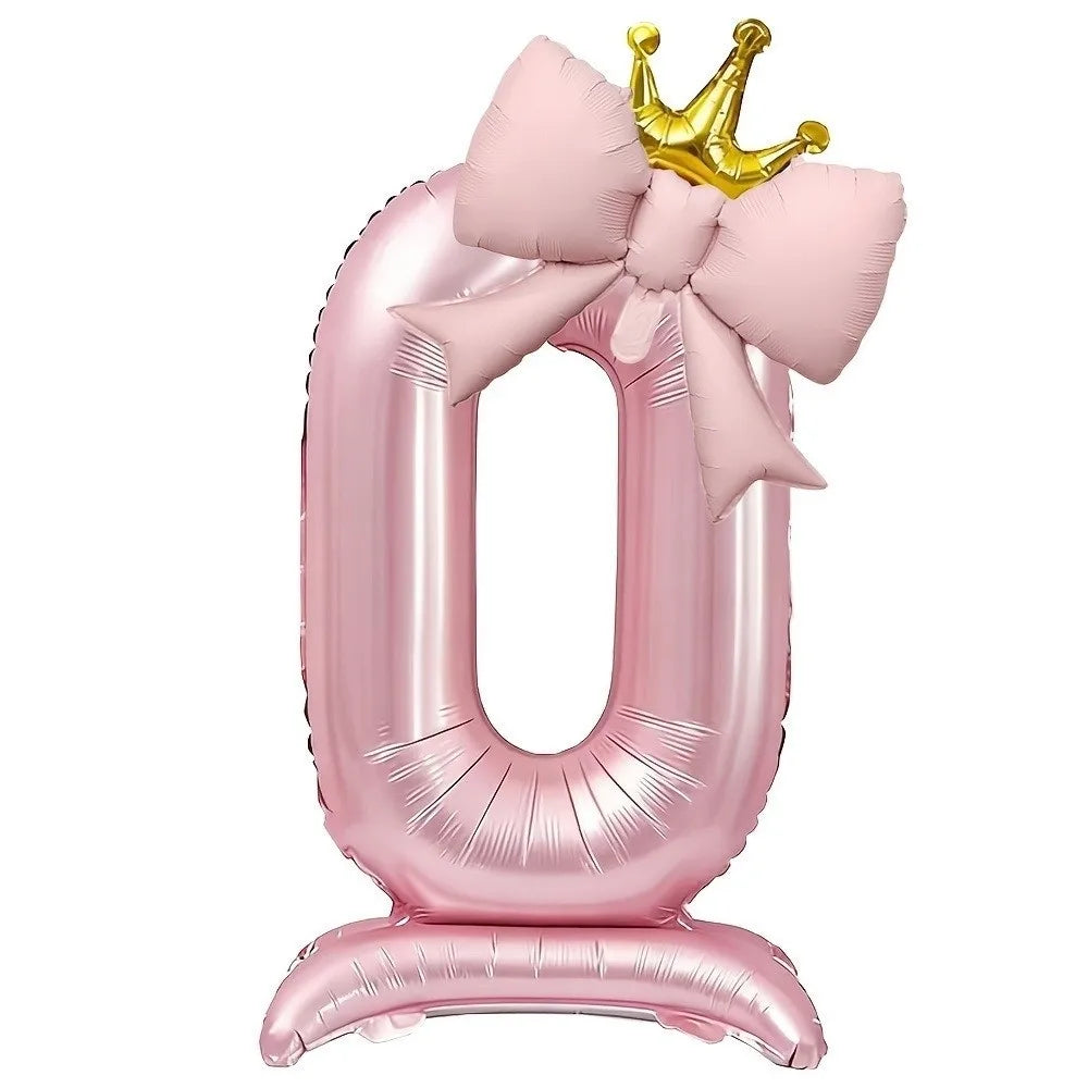 A large pink foil balloon shaped like the number 4, topped with a gold crown.