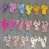 A collection of lifelike butterfly orchid stems featuring various shades of purple, pink, blue, and yellow blooms.