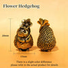 A brass flower hedgehog statue shown from the top, with a measurement scale indicating its size.