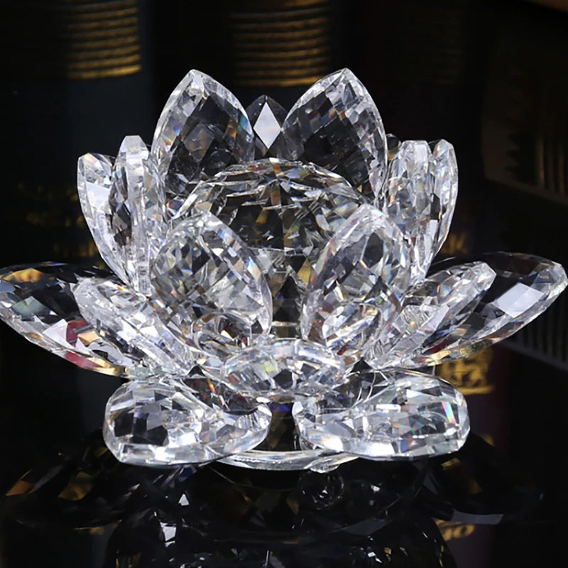 A clear crystal lotus flower ornament with multiple petals displayed on a reflective surface.