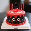 A birthday cake decorated with red and black candles shaped like the number three and a mouse design.