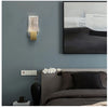 Modern bubble crystal LED wall sconces mounted on a gray wall above a dark bed.
