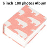 A pink 6 inch photo album with a white border featuring a repeating white cartoon animal pattern.