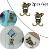 A set of two decorative brass metal wall hooks shaped like leaping animals for kitchen or bathroom decor.