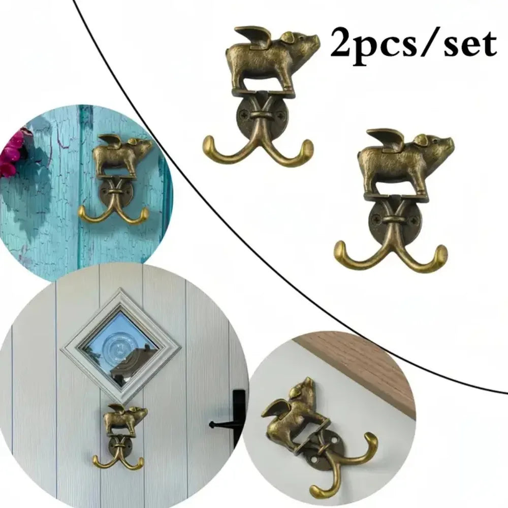 A set of two decorative brass metal wall hooks shaped like leaping animals for kitchen or bathroom decor.