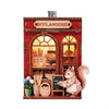 A wooden layered puzzle magnet decor featuring a brick storefront with a sign and a small rabbit figure.