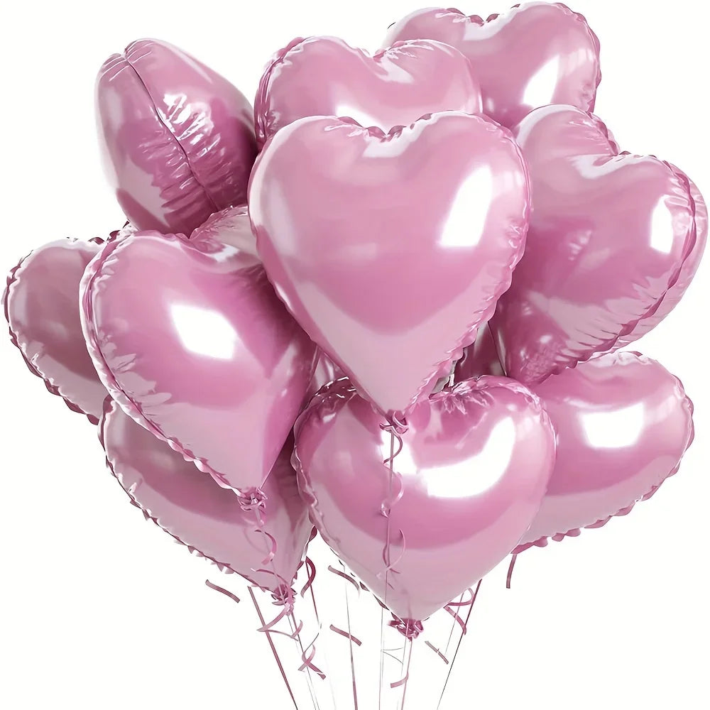 A bunch of ten shiny pink heart-shaped foil balloons tied together.