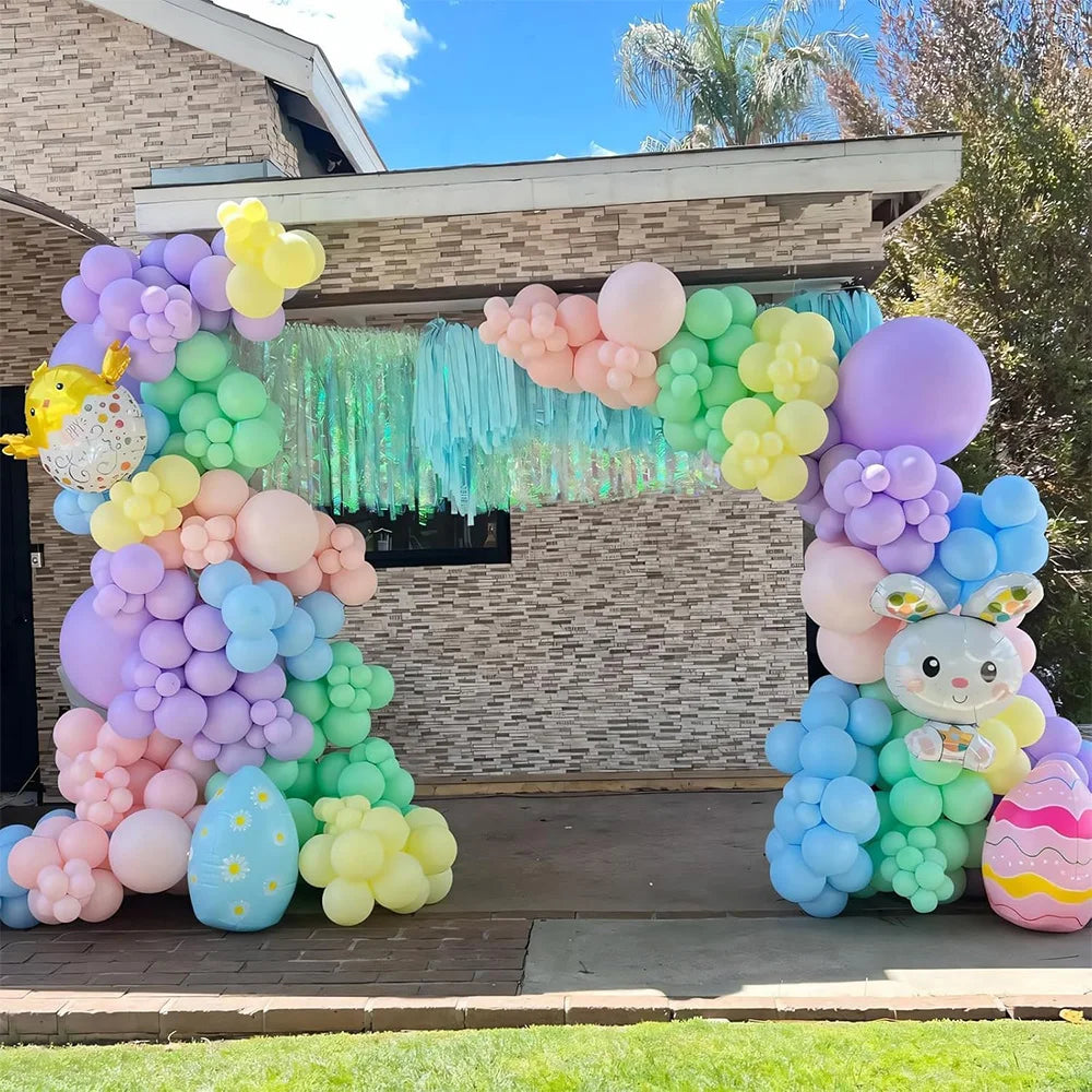 A colorful archway made of pastel rainbow latex balloons for party décor