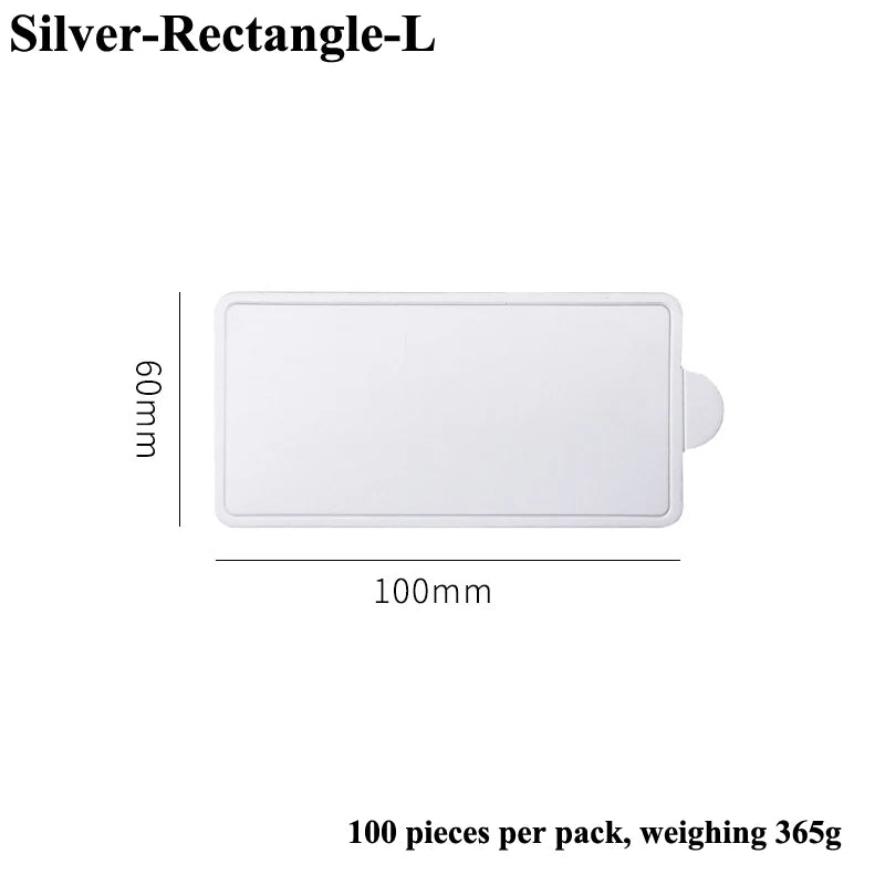 A white rectangular silver dessert cake board measuring 100mm by 60mm, sold in a pack of 100 pieces.