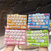 A collection of colorful cartoon animal keycap fidget toys arranged in various layouts and colors.